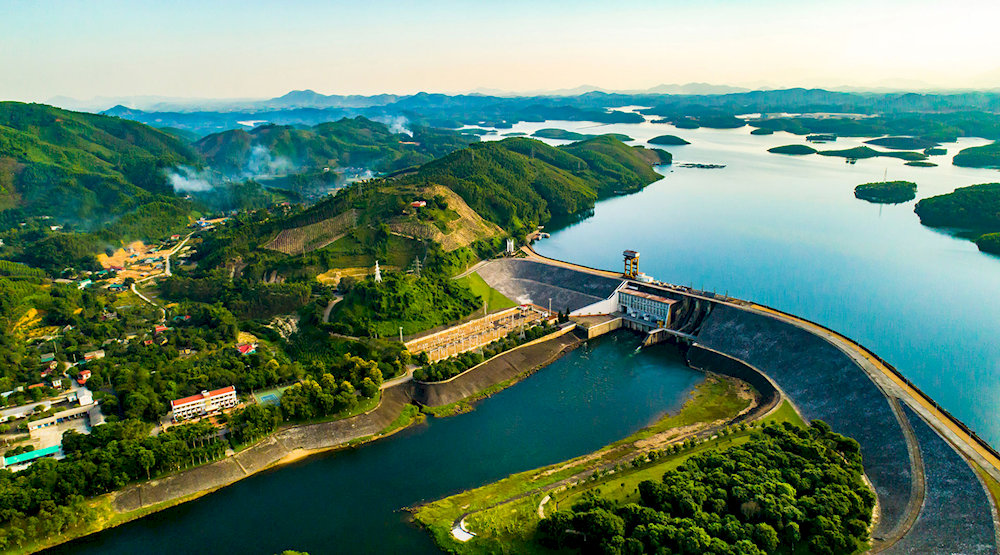 The monumental Thac Ba Hydropower Plant beside calm reservoir waters